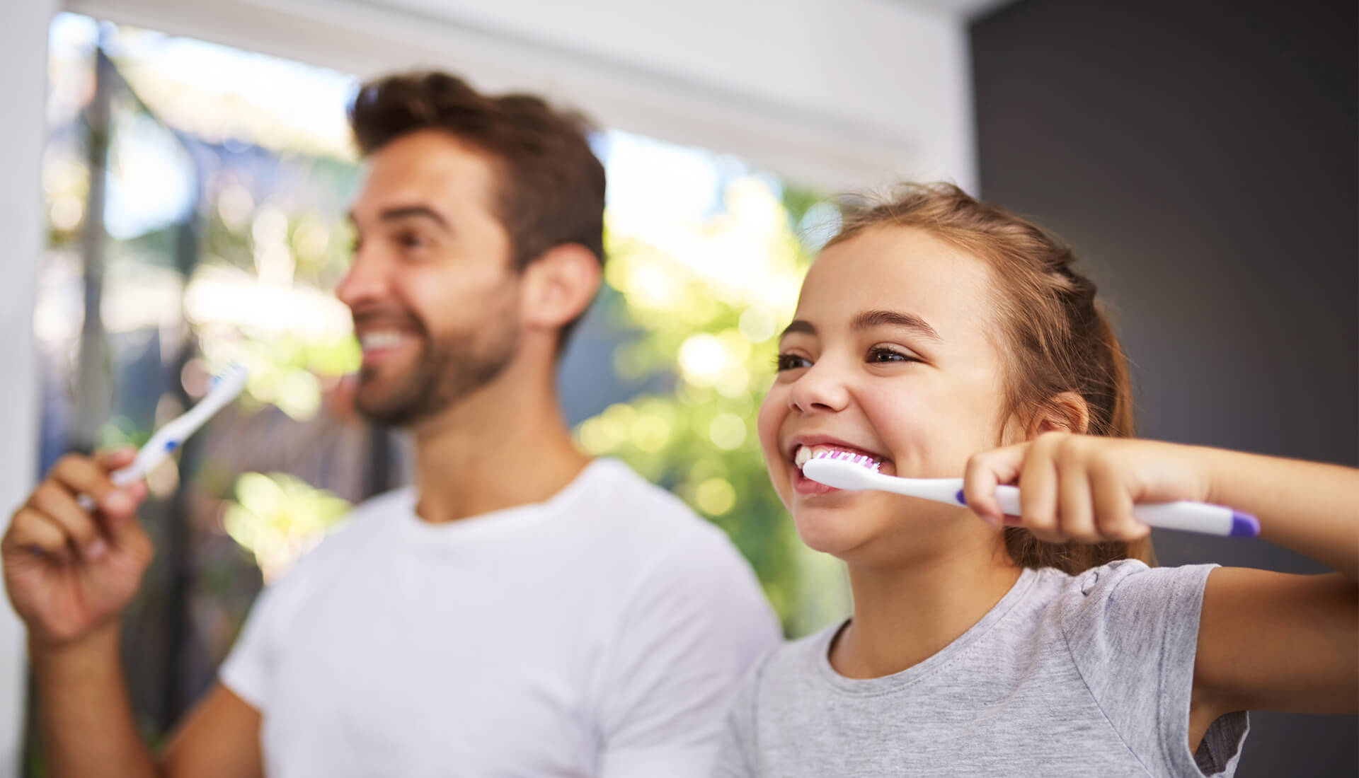 dad-and-daughter-brushing-teeth