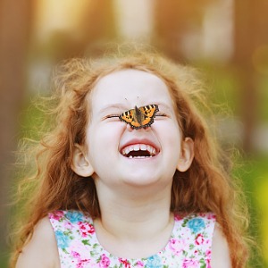 Little girl with butterfly on her nose